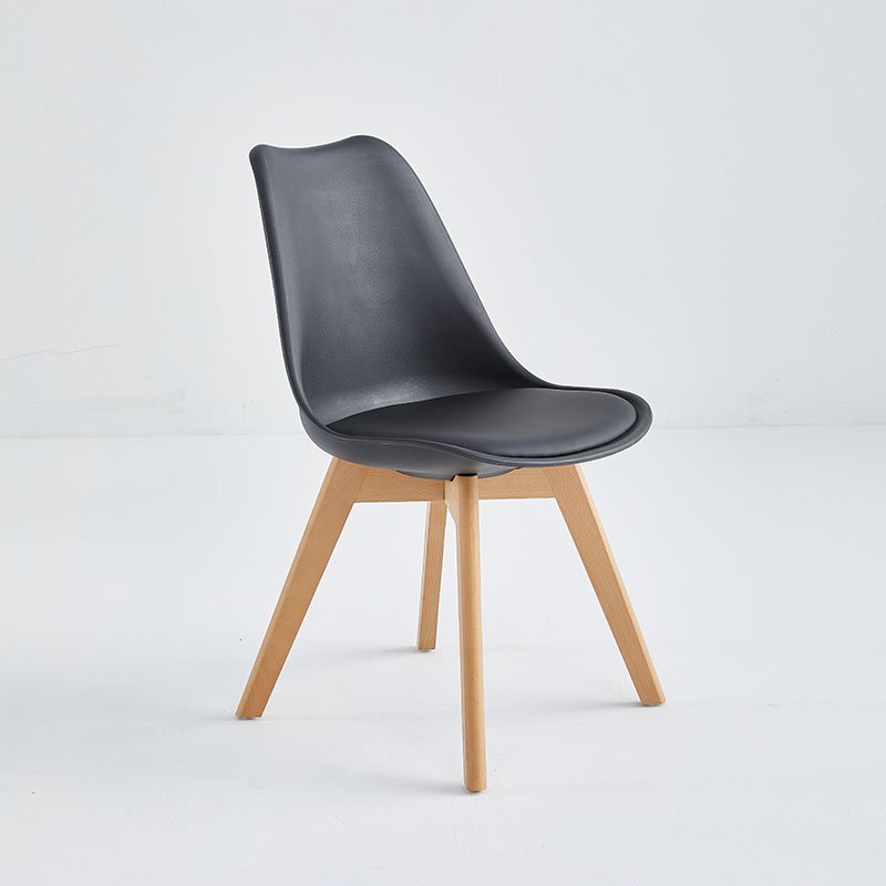 Black upholstered restaurant chair with wooden legs.